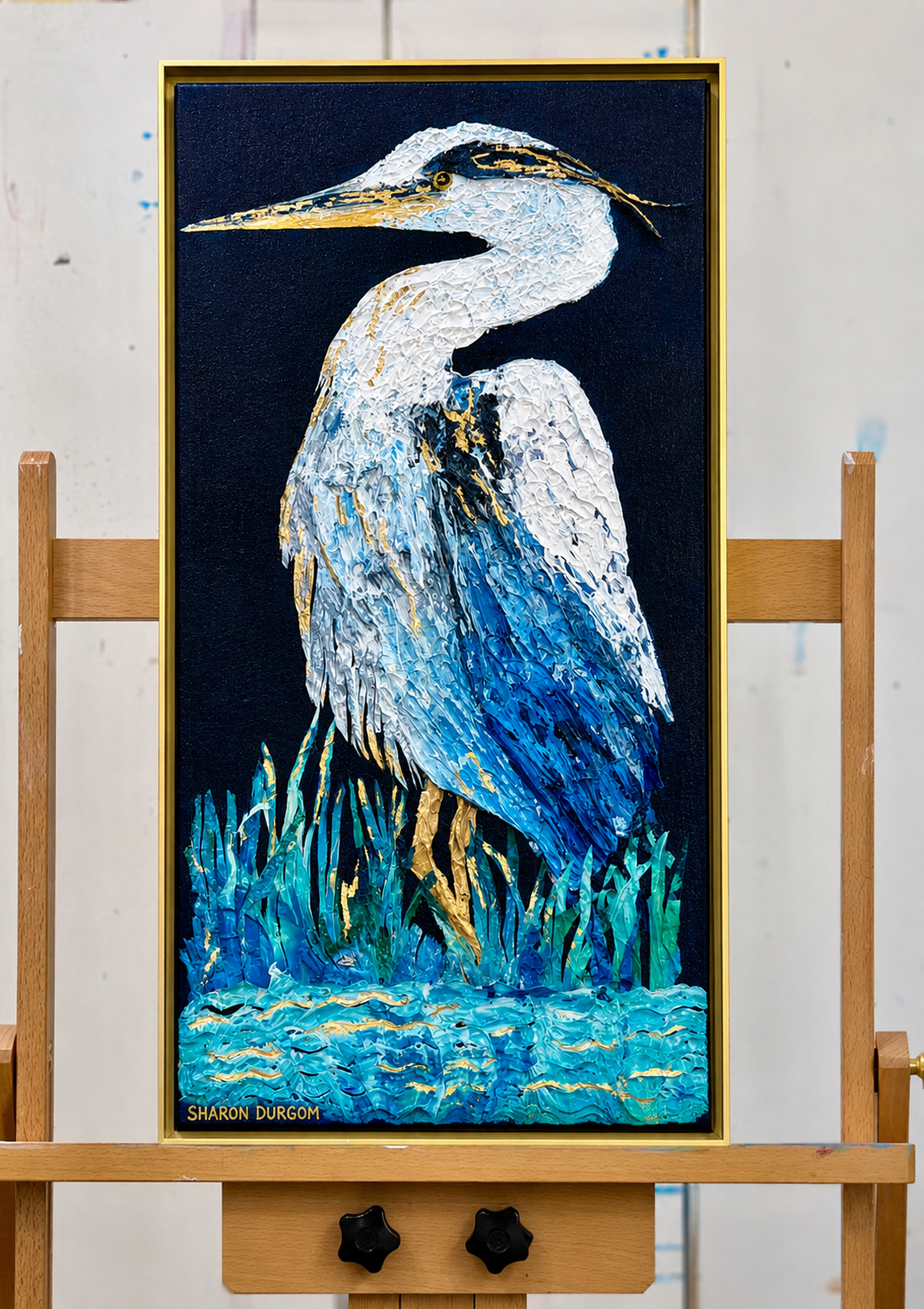 Harper the Heron original heron painting displayed on an easel in the artist's studio