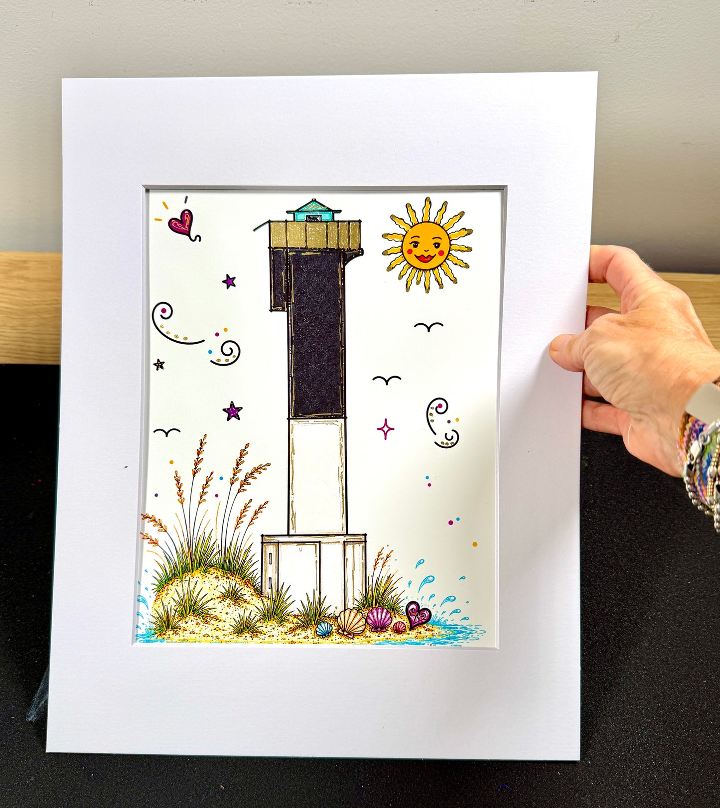 Framed Sullivan's Island Lighthouse artist embellished print in white mat.