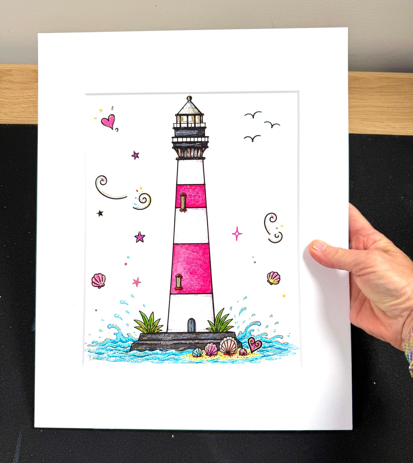 Close-up of Morris Island Lighthouse with hand-painted metallic gold embellishments.