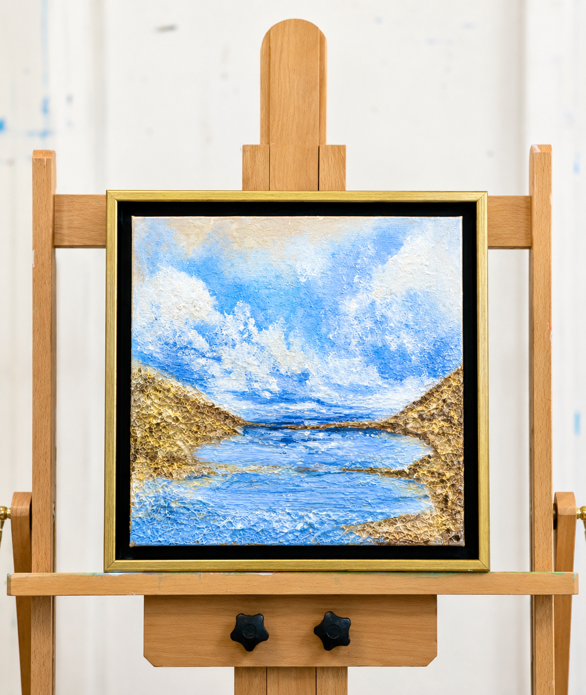 Golden Passage original coastal landscape painting displayed on an artist's easel by Sharon Durgom.